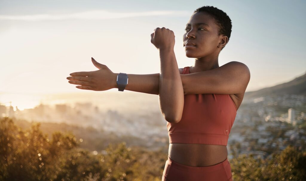 Exercise, fitness and black woman stretching arm outdoors for health and wellness. Thinking, sports